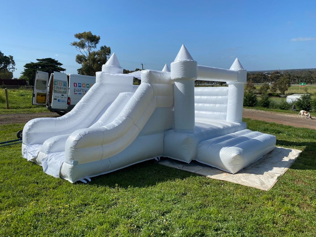 Elegant white wedding jumping castle with slide - premium hire option in Cape Town